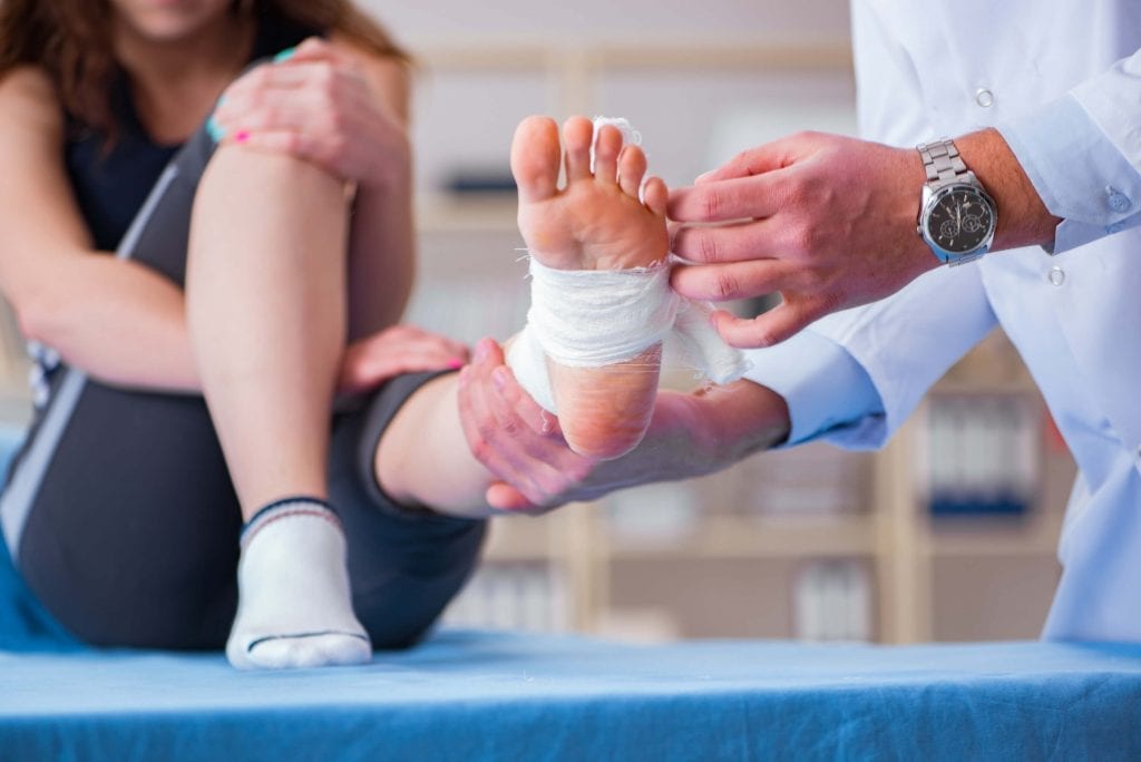 During ankle arthroscopy consultation, woman talks to surgeon