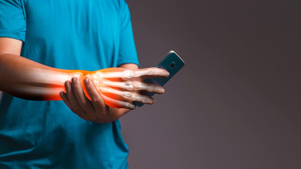 man suffers from pain caused by carpal tunnel syndrome